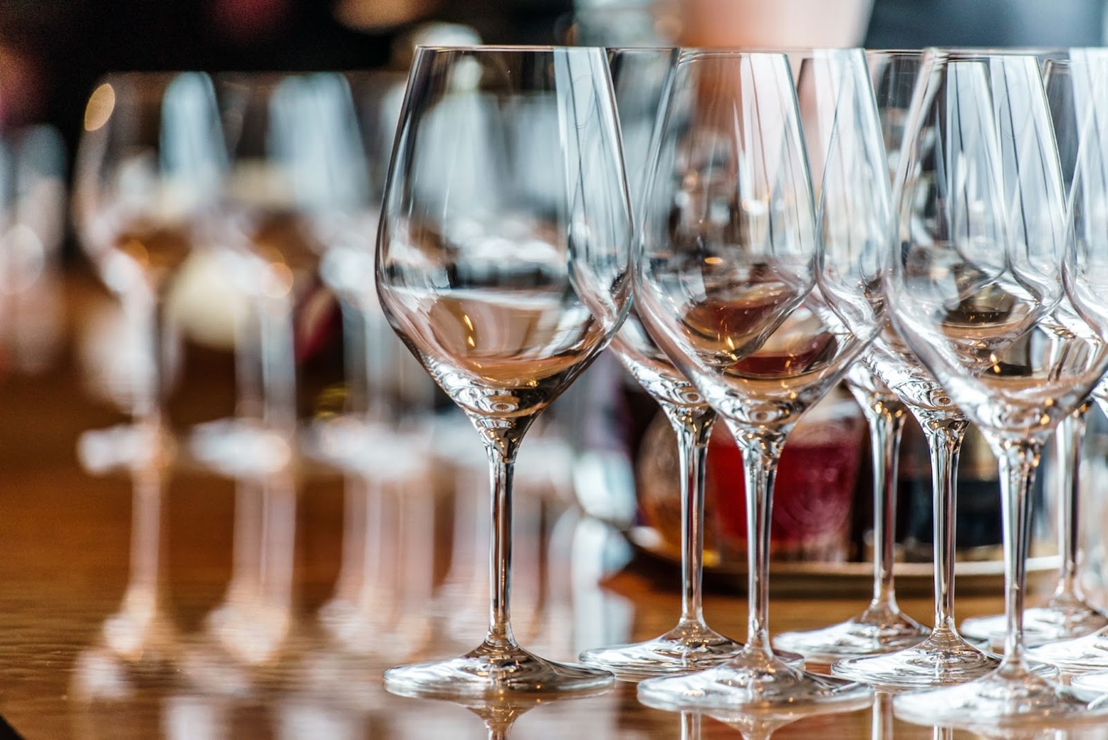 Sparkling wine glasses elegantly arranged on a polished bar counter, showcasing their clarity and shine.